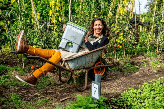 Woman takes her fermented bokashi compost into the garden