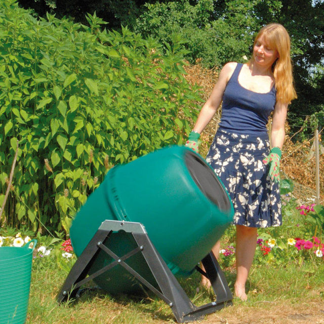 A compost tumbler in a sunny position in the Lean Green Home